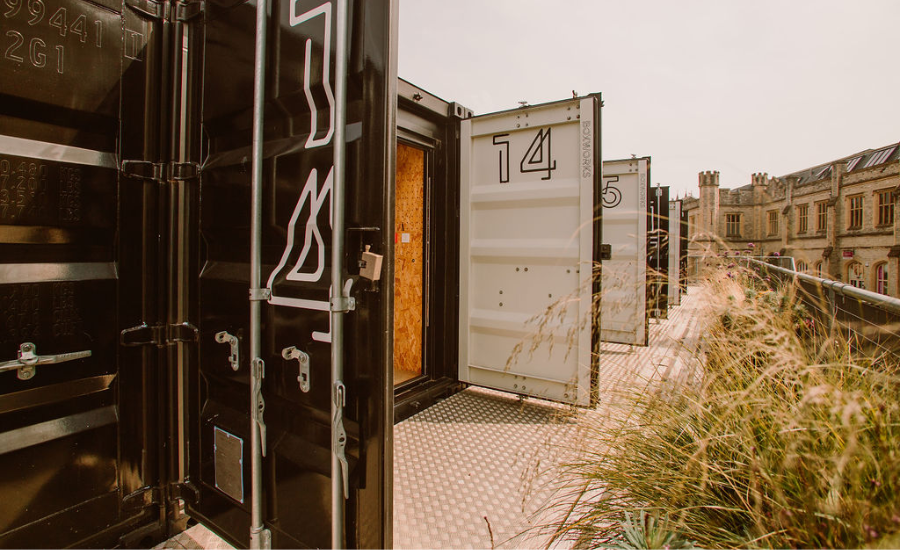 Black, numbered Boxworks shipping containers with the doors open