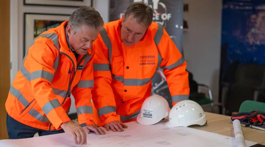 Colin Skellett & Dan Norris inspect plans for the new station at Brabazon