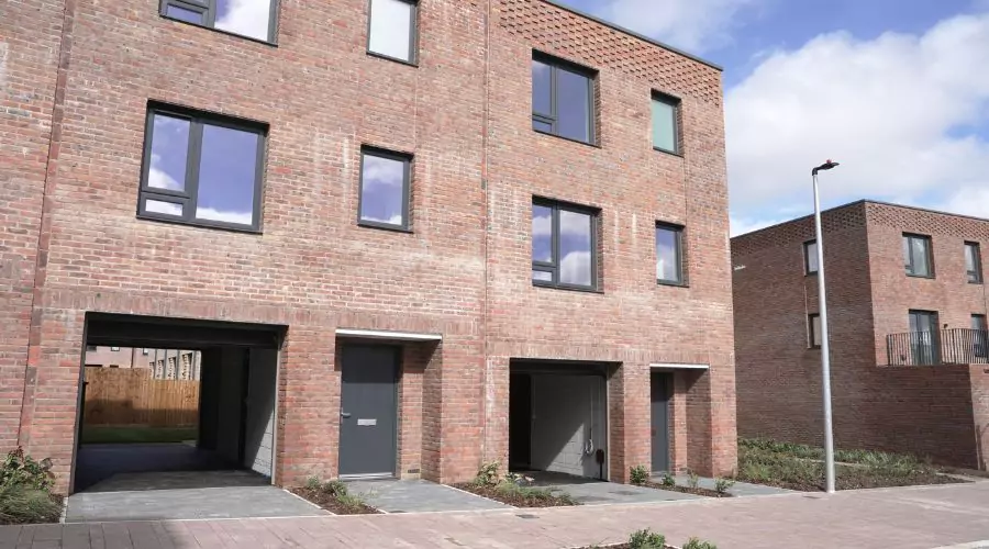 Modern, brick, three storey affordable homes located on Smart Street in North Bristol.