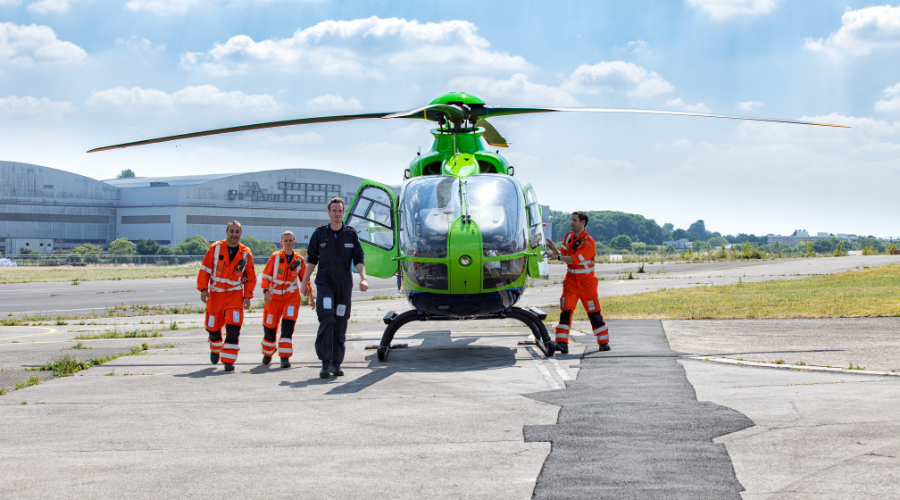 Great Western Air Ambulance crew in front of a helicopter